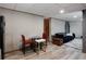 Features dining area with modern table and chairs, adjacent to the living room at 1429 Smithson Dr, Lithonia, GA 30058