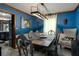 Bright dining room with stylish decor, modern lighting, and a view of the adjacent kitchen at 1429 Smithson Dr, Lithonia, GA 30058