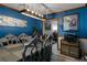 Dining room with blue walls, wood trim, modern light fixture, and decorative artwork providing an elegant atmosphere at 1429 Smithson Dr, Lithonia, GA 30058