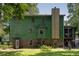 Exterior of the home with green siding, a brick foundation, and a cozy back porch at 1429 Smithson Dr, Lithonia, GA 30058