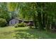 House with green lawn, mature trees, and a covered front porch, creating a peaceful and inviting exterior at 1429 Smithson Dr, Lithonia, GA 30058