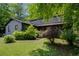 Home with mature trees and shrubs, a covered front porch, and a well-maintained lawn at 1429 Smithson Dr, Lithonia, GA 30058