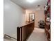 Hallway with view to open door, wooden railing, and shelves with purses, shoes, and bags at 1429 Smithson Dr, Lithonia, GA 30058
