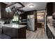 Kitchen with dark wood cabinets, stainless steel appliances, and light countertops providing a functional and stylish cooking space at 1429 Smithson Dr, Lithonia, GA 30058