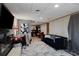Spacious living room area featuring a comfortable couch, large television, and adjacent dining area at 1429 Smithson Dr, Lithonia, GA 30058