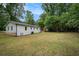 Spacious backyard offers ample room for recreation and gardening, surrounded by mature trees at 3952 Leisure Se Ct, Conyers, GA 30013