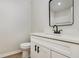 This half bath features a modern vanity with stone countertop and black hardware accents at 3952 Leisure Se Ct, Conyers, GA 30013