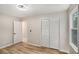 An empty bedroom with closet, wood-look floors, and access to an ensuite bath at 3952 Leisure Se Ct, Conyers, GA 30013