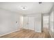 A bright empty bedroom with wood-look floors, a closet, and access to the bathroom at 3952 Leisure Se Ct, Conyers, GA 30013