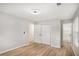 Bedroom with laminate floors, neutral walls and views to a closet and bathroom via white doors at 3952 Leisure Se Ct, Conyers, GA 30013