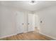 An empty bedroom with two closets, wood-look floors, and access to a bathroom at 3952 Leisure Se Ct, Conyers, GA 30013