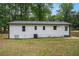 Exterior view of the home showcasing the well-maintained siding, windows, and backyard at 3952 Leisure Se Ct, Conyers, GA 30013