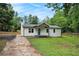 Attractive one-story home boasting a covered porch, a blue front door, and a well-maintained lawn, perfect for a Gathering at 3952 Leisure Se Ct, Conyers, GA 30013