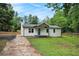 Charming single-story home with white siding, concrete driveway, and a bright blue front door at 3952 Leisure Se Ct, Conyers, GA 30013