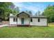 Charming single-story home with white siding, covered front porch and a bright blue front door at 3952 Leisure Se Ct, Conyers, GA 30013