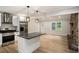 Modern kitchen featuring stainless steel appliances, sleek countertops, a center island, and hardwood floors at 3952 Leisure Se Ct, Conyers, GA 30013