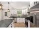 Gorgeous kitchen with white cabinetry, stainless appliances, island, and wood-look flooring at 3952 Leisure Se Ct, Conyers, GA 30013