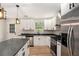 Well-designed kitchen with white cabinets, stainless steel appliances, an island, and pendant lighting for a sleek modern look at 3952 Leisure Se Ct, Conyers, GA 30013
