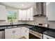 This modern kitchen features white shaker cabinets and stainless-steel appliances at 3952 Leisure Se Ct, Conyers, GA 30013