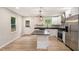 Modern kitchen featuring white cabinets, stainless steel appliances, a center island, and hardwood floors at 3952 Leisure Se Ct, Conyers, GA 30013