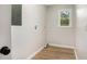 Bright laundry room with laminate floors and natural light from a window overlooking the yard at 3952 Leisure Se Ct, Conyers, GA 30013