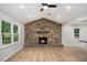 Cozy living room features a stone fireplace, ceiling fan, recessed lighting and wood-look flooring at 3952 Leisure Se Ct, Conyers, GA 30013