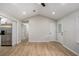 Spacious living room offering hardwood floors, a hallway entrance, and connects to a modern kitchen with stainless steel appliances at 3952 Leisure Se Ct, Conyers, GA 30013