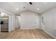 Living room features wood-look floors, neutral paint, access to the backyard and an open doorway to the kitchen at 3952 Leisure Se Ct, Conyers, GA 30013