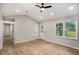 Bright living room featuring hardwood floors, a vaulted ceiling with recessed lighting, and a large window with backyard views at 3952 Leisure Se Ct, Conyers, GA 30013