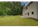 A sprawling backyard view reveals a large green lawn, bordered by a patio and a garden area at 4942 Brown Leaf Dr, Powder Springs, GA 30127