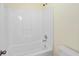 Bright bathroom showcasing bathtub with white shower insert at 4942 Brown Leaf Dr, Powder Springs, GA 30127
