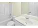 Bright bathroom featuring a tub with shower, white vanity and neutral wall color at 4942 Brown Leaf Dr, Powder Springs, GA 30127