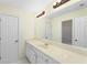 Bathroom with light vanity and long mirror at 4942 Brown Leaf Dr, Powder Springs, GA 30127