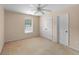 A clean bedroom includes neutral carpeting, a ceiling fan, and a window for natural light at 4942 Brown Leaf Dr, Powder Springs, GA 30127