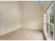 Bright, carpeted bedroom with vaulted ceilings, large window, and neutral tones, offering a cozy retreat at 4942 Brown Leaf Dr, Powder Springs, GA 30127