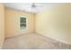 Neutral bedroom showcasing a ceiling fan, window, light yellow walls and carpet floors at 4942 Brown Leaf Dr, Powder Springs, GA 30127