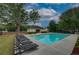 Community pool with plenty of lounge chairs for residents to enjoy in a fenced outdoor space at 4942 Brown Leaf Dr, Powder Springs, GA 30127