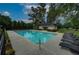 Community swimming pool featuring lounge chairs, a small building, and well-maintained grounds at 4942 Brown Leaf Dr, Powder Springs, GA 30127