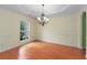 Spacious dining room with hardwood floors, tray ceiling, chandelier, and wainscoting, ideal for entertaining at 4942 Brown Leaf Dr, Powder Springs, GA 30127