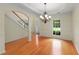Elegant dining room with hardwood floors, tray ceiling, chandelier, and large window, perfect for gatherings at 4942 Brown Leaf Dr, Powder Springs, GA 30127