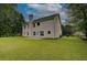 Rear view of the home with a spacious backyard and mature trees surrounding the property at 4942 Brown Leaf Dr, Powder Springs, GA 30127