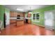 Charming kitchen with an island, stainless steel appliances, wooden cabinets and hardwood floors at 4942 Brown Leaf Dr, Powder Springs, GA 30127