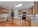 Bright kitchen with stainless steel appliances, wood cabinets, granite countertops and an island at 4942 Brown Leaf Dr, Powder Springs, GA 30127
