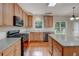 Bright kitchen featuring stainless appliances, granite countertops, island, and hardwood floors at 4942 Brown Leaf Dr, Powder Springs, GA 30127