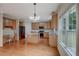 Light-filled kitchen featuring hardwood floors, stainless steel appliances, and an island at 4942 Brown Leaf Dr, Powder Springs, GA 30127
