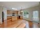 Eat-in kitchen featuring an island, stainless steel appliances, light wood cabinets and hardwood floors at 4942 Brown Leaf Dr, Powder Springs, GA 30127