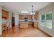 Spacious kitchen featuring stainless steel appliances, an island, wood cabinets and eat-in area at 4942 Brown Leaf Dr, Powder Springs, GA 30127
