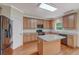 Well-lit kitchen with stainless steel appliances, wood floors, and a granite-topped center island at 4942 Brown Leaf Dr, Powder Springs, GA 30127