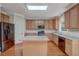 Modern kitchen featuring stainless steel appliances, light wood cabinets, an island and hardwood floors at 4942 Brown Leaf Dr, Powder Springs, GA 30127