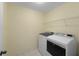 The laundry room includes a washer and dryer, and built-in shelving for storage at 4942 Brown Leaf Dr, Powder Springs, GA 30127